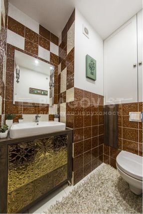 A Stylish And Well-Maintained Bathroom Featuring m...