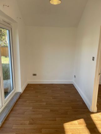 A Bright, Clean Empty Room With Wooden Flooring An...