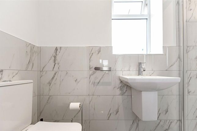 A Bright And Clean Bathroom Featuring Modern White...
