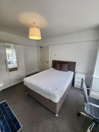A Clean And Well-Lit Double Bedroom Featuring A Co...