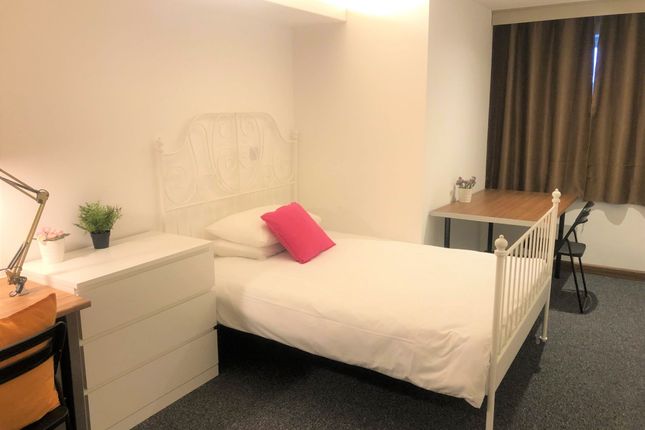 A Bright And Tidy Single Bedroom Featuring A White...