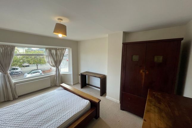 A Bright And Airy Bedroom Featuring A Large Window...