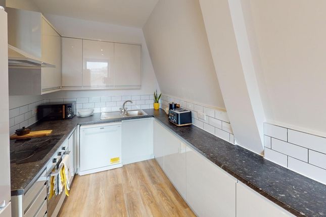 A Modern Kitchenette With Sleek Finishes And Plent...