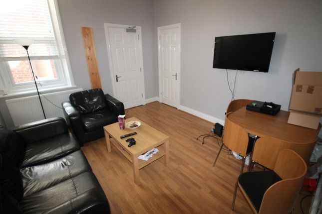Bright And Spacious Living Room Featuring Comforta...