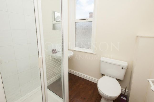 A Bright And Tidy Bathroom Featuring A Shower, Per...