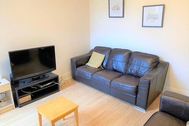 A Cozy Living Room Featuring A Comfortable Leather...
