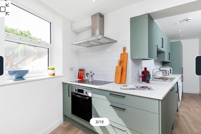 A Modern And Well-Lit Kitchenette Featuring Stylis...