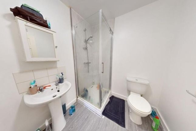 A Modern Bathroom Suite Featuring A Clear Glass Sh...