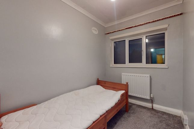 A Simple And Neat Bedroom Featuring A Single Woode...