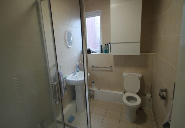 A Modern Bathroom With A Toilet, Sink, And Shower ...