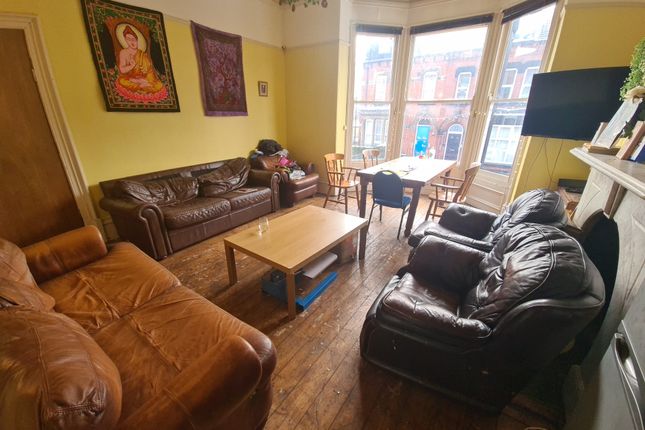 A Cozy And Inviting Living Room Featuring Large Ba...