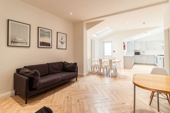 A Bright And Spacious Living Area Featuring A Comf...