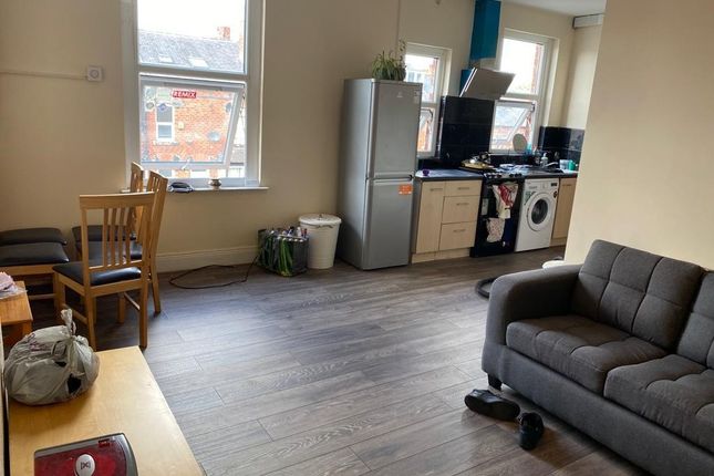 A Spacious Living Area Featuring Large Windows Pro...