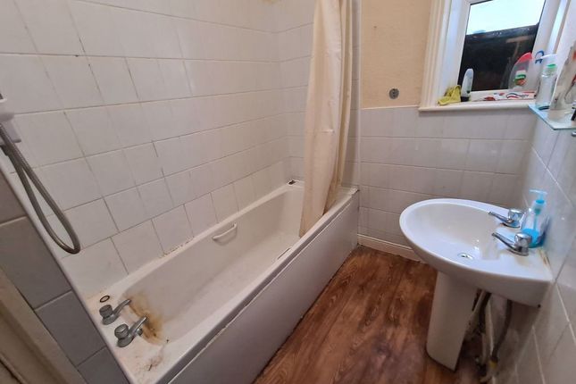 A Clean And Functional Bathroom Featuring A Bathtu...