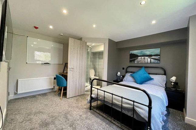 This Inviting Double Bedroom Features A Comfortabl...