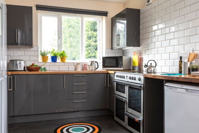 Modern Kitchen Featuring A Large Window Bringing i...