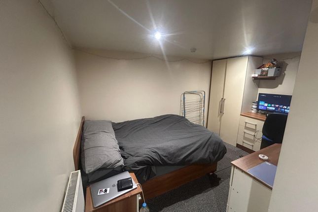 A Cozy Bedroom Featuring A Double Bed With Dark Be...