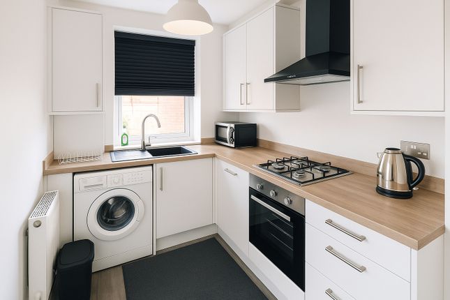 Modern And Tidy Kitchen Featuring Sleek White Cabi...