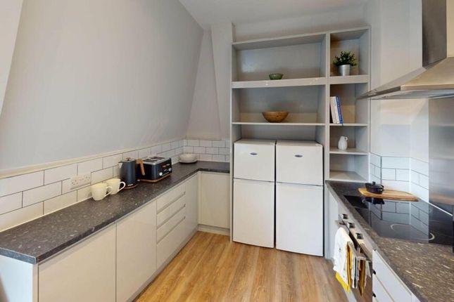 A Modern And Tidy Kitchenette With Ample Storage A...