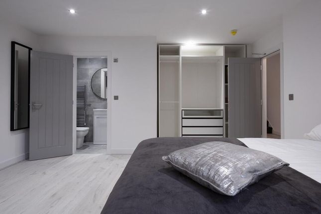 A Bright And Modern Master Bedroom Featuring A Com...