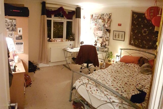 Cozy Bedroom Featuring A Single Metal-Framed Bed W...