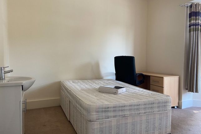 A Small, Tidy Room Featuring A Toilet And Minimal ...