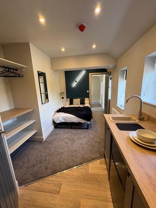 A Modern, Well-Lit Single Bedroom Featuring A Cozy...