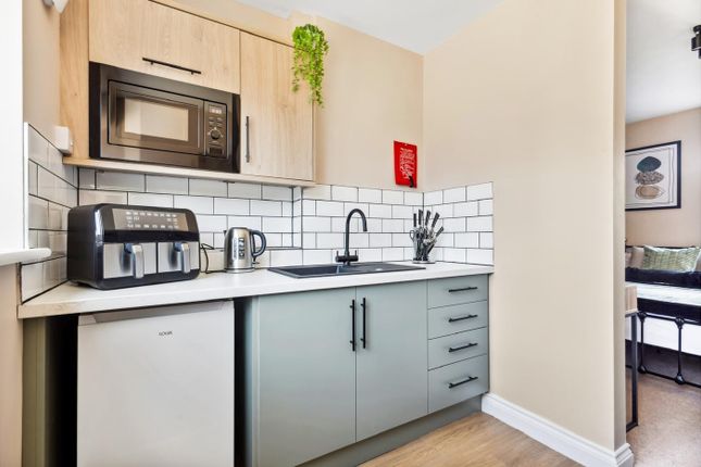 This Modern Kitchen Features Sleek Cabinetry, A St...