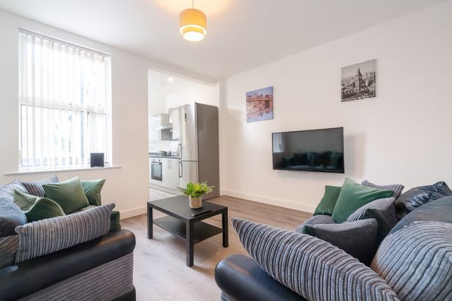 Bright And Welcoming Living Room Featuring Comfort...