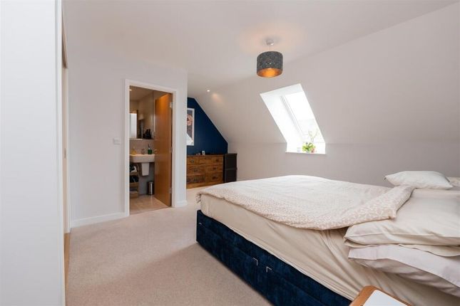 A Bright And Cozy Master Bedroom Featuring A Large...