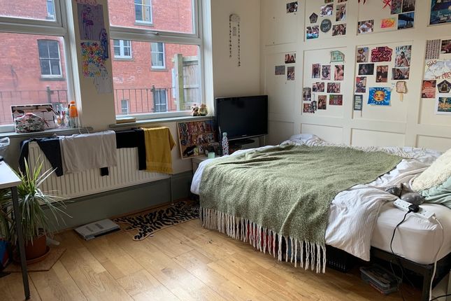 A Bright Double Bedroom Featuring Large Windows Th...