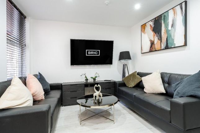 A Stylish And Modern Living Room Featuring Plush S...