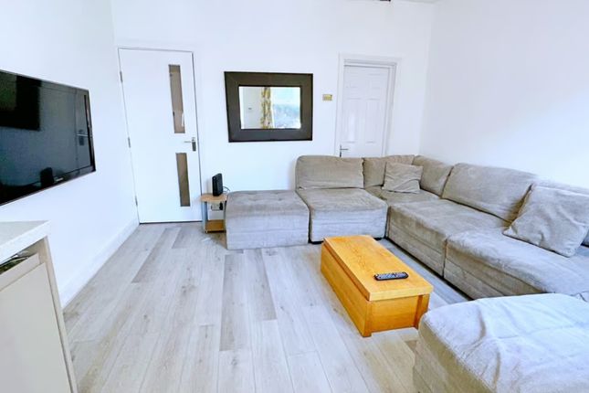 A Cozy And Inviting Living Room Featuring A Spacio...