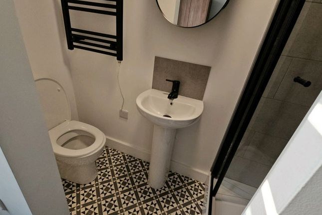 A Modern Bathroom Featuring Stylish Patterned Floo...