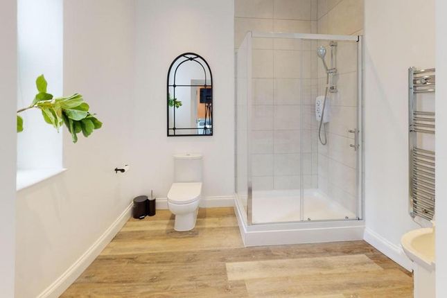 A Bright And Modern Bathroom Featuring A Spacious ...