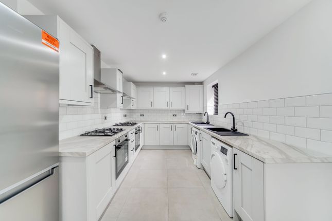 Modern, Bright Kitchen Featuring Sleek White Cabin...
