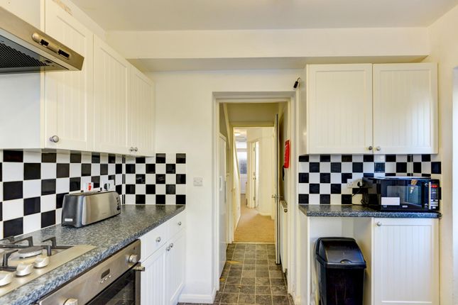 A Compact, Well-Maintained Kitchen Featuring Black...