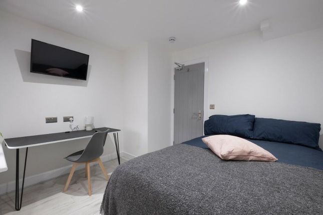 A Spacious And Modern Master Bedroom Featuring A l...