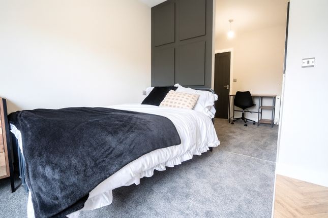 A Bright, Modern Bedroom Featuring A Comfortable d...