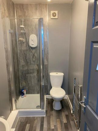 A Modern And Tidy Bathroom Featuring A Sleek Showe...