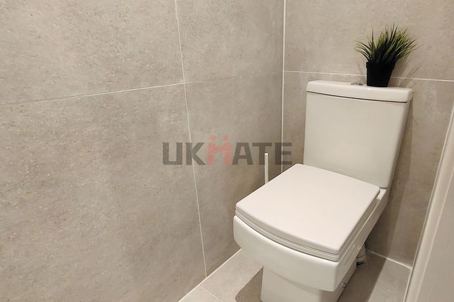 A Clean, Modern Bathroom With Neutral Tiled Walls ...