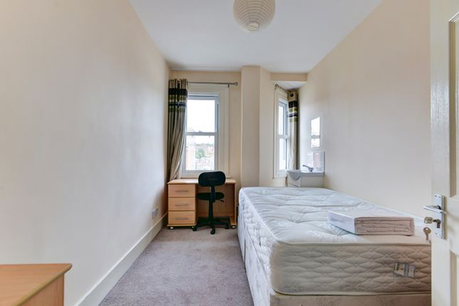 A Bright And Tidy Bedroom Featuring A Single Bed P...