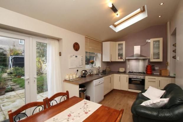 A Bright, Modern Kitchen Featuring A Skylight And ...