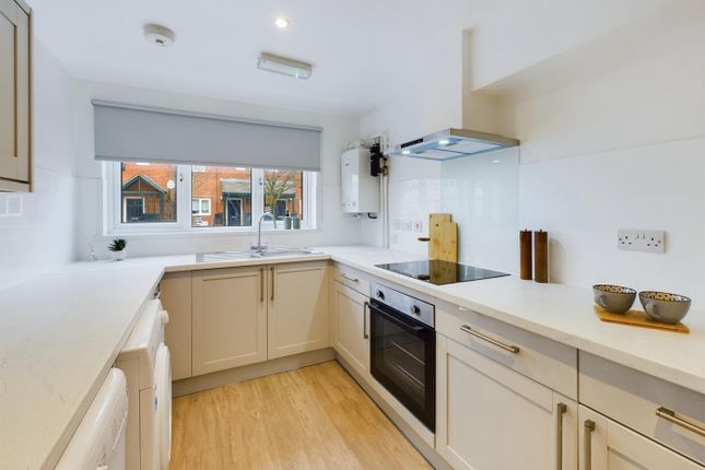 A Bright And Modern Kitchen With Ample Counter Spa...
