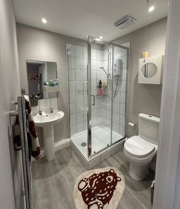A Modern Bathroom Featuring A Sleek Glass Shower, ...