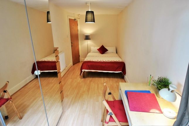 A Neat And Comfortable Single Bedroom Featuring A ...