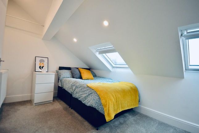 This Inviting Double Bedroom Features A Cozy Bed A...