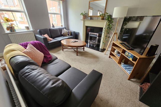 A Bright And Inviting Living Room Featuring Comfor...