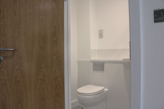 A Pristine And Modern Single Toilet, Featuring A c...