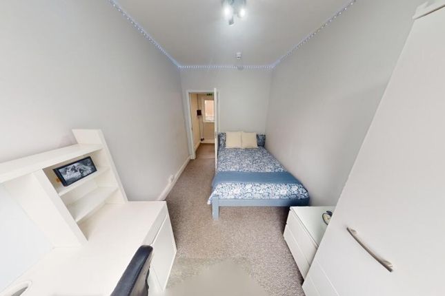 A Neat And Bright Single Bedroom Featuring A Simpl...